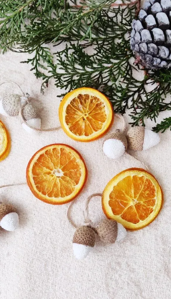 Deco idea Navidad: Guirnalda con naranjas secas y bellotas decorativas